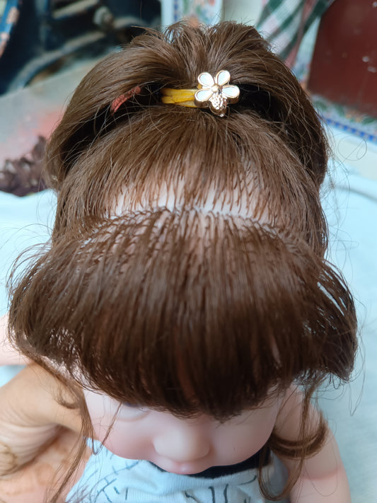 Tiny Darling long hand-rooted hair close up top view