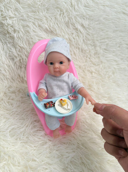 Sunshine Baby silicone doll in pink tub on fluffy background
