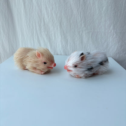 Two miniature silicone pig dolls - cream and spotted variants