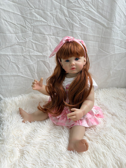 Reborn toddler girl doll sitting - close up