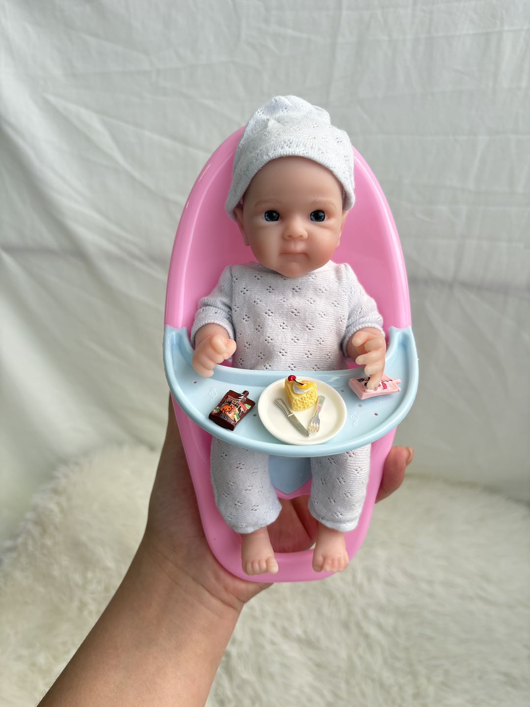 Sunshine Baby silicone doll in pink baby tub with food tray