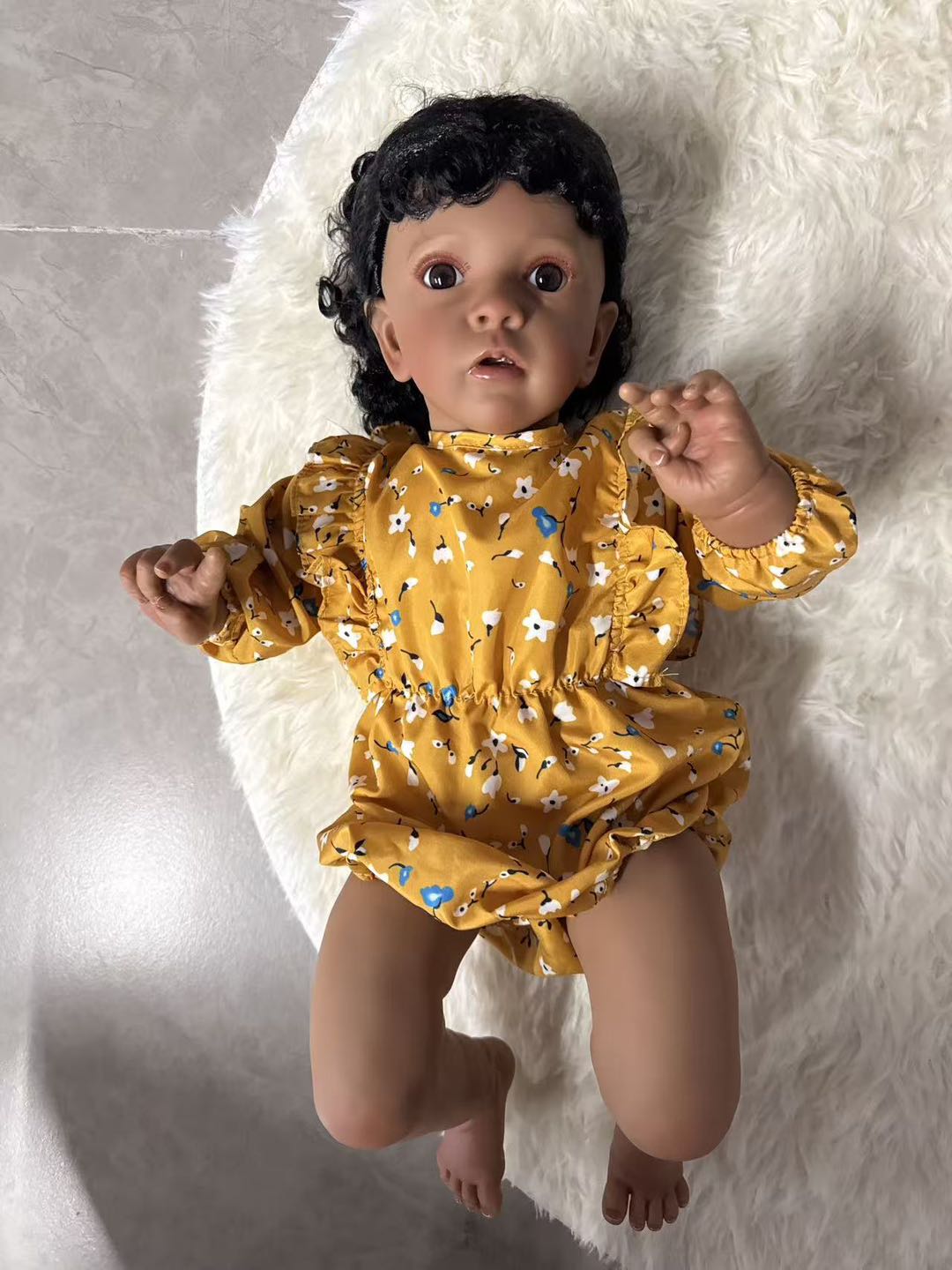 African Reborn Baby Doll - Mustard Yellow Floral Romper real photo